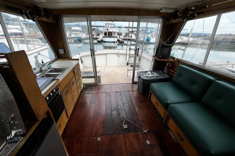 Slide: The Image of Interior of 1974 Tollycraft 37 Convertible yacht with wood flooring and marina view. - 29
