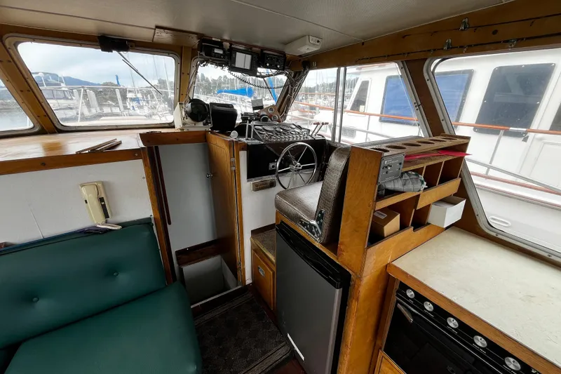 Slide: The Image of 1974 Tollycraft 37 Convertible boat interior with helm, seating, and storage. - 23