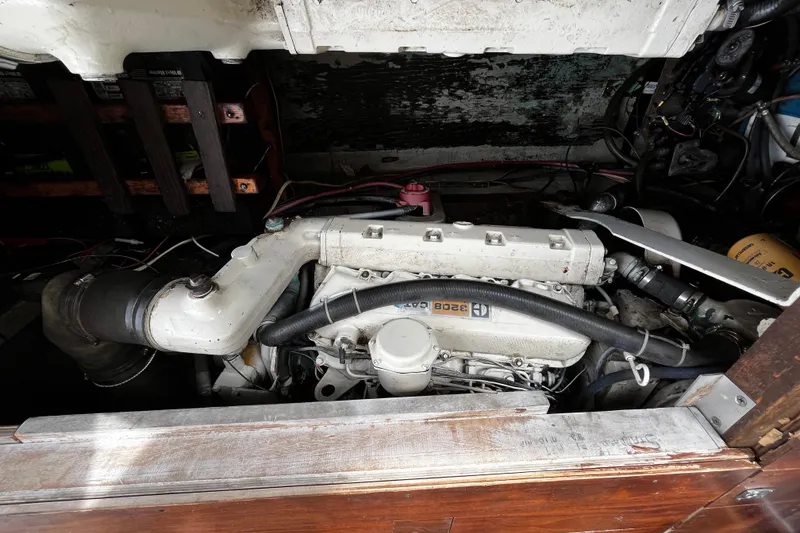 Slide: The Image of Engine compartment of a 1974 Tollycraft 37 Convertible boat, showcasing mechanical components. - 43