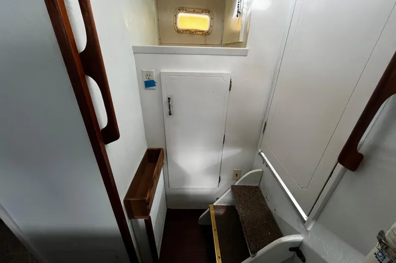 Slide: The Image of 1974 Tollycraft 37 Convertible interior with stairs and wooden accents. - 32