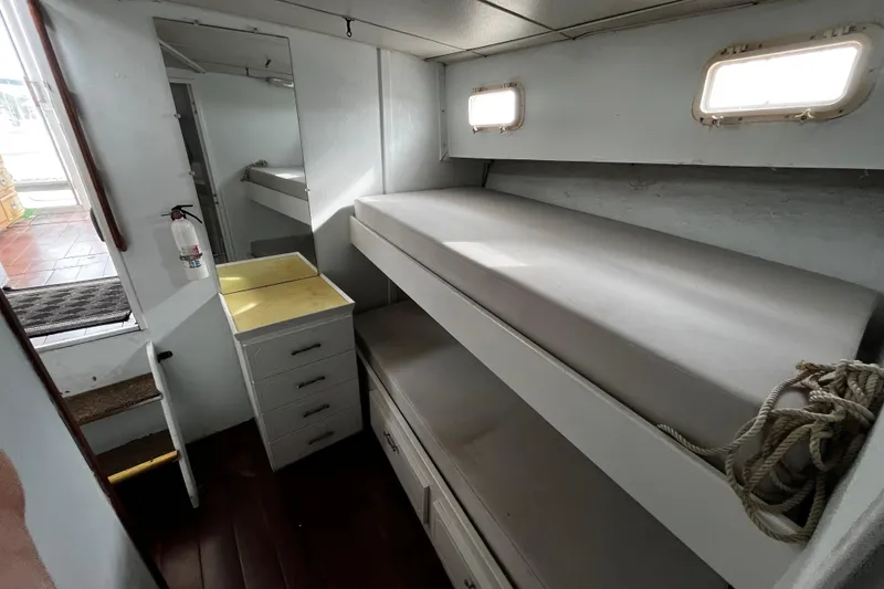 Slide: The Image of 1974 Tollycraft 37 Convertible interior with bunk beds and storage drawers. - 35