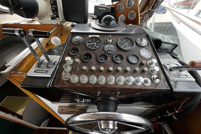 Slide: The Image of 1974 Tollycraft 37 Convertible boat dashboard with gauges and controls. - 27