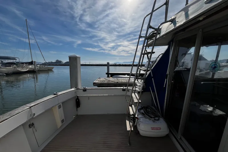 Slide: The Image of 1974 Tollycraft 37 Convertible boat docked at a marina under a clear blue sky. - 16
