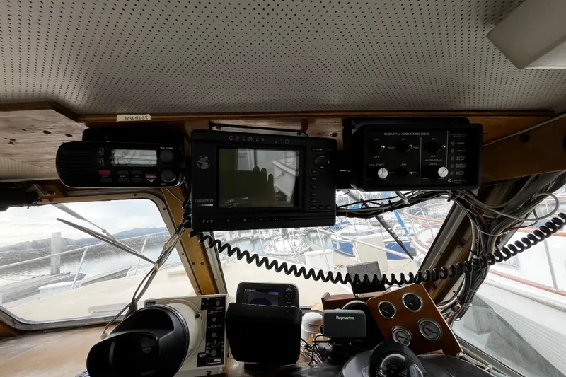 Slide: The Image of 1974 Tollycraft 37 Convertible helm with navigation equipment and gauges. - 26