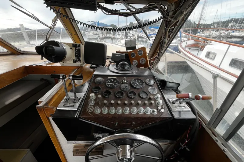 Slide: The Image of 1974 Tollycraft 37 Convertible helm with vintage controls and marina view. - 28