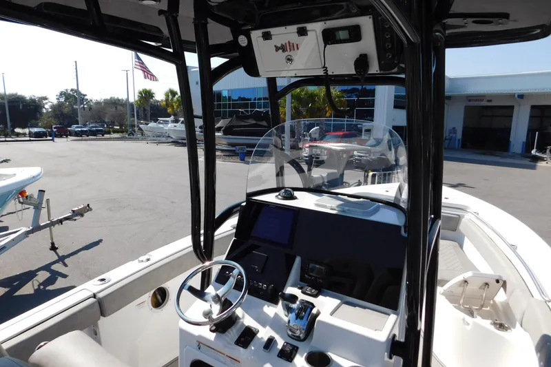 Slide: The Image of 2021 Sea Pro 219 Center Console boat interior with steering wheel and controls. - 13