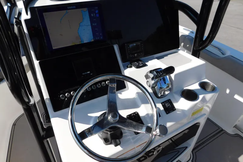 Slide: The Image of 2021 Sea Pro 219 Center Console boat dashboard with steering wheel and navigation display. - 18