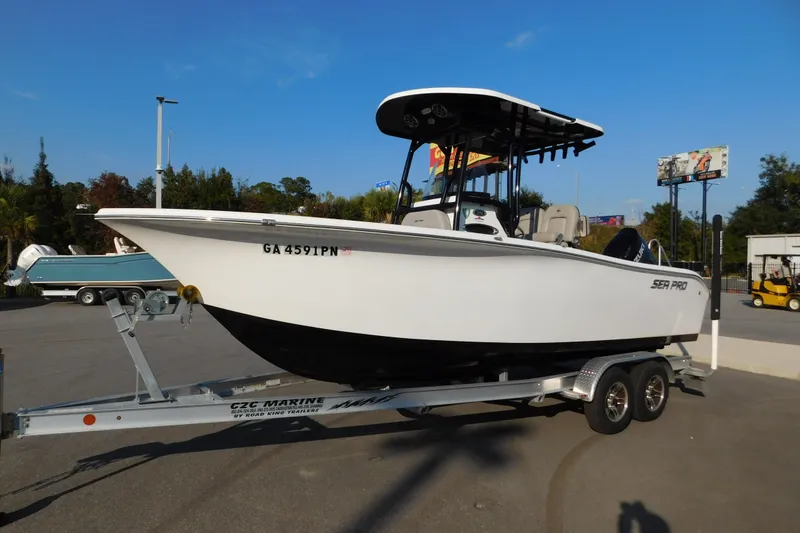 Slide: The Image of 2021 Sea Pro 219 Center Console boat on trailer in parking lot. - 2