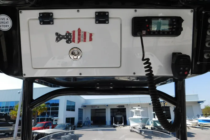 Slide: The Image of 2021 Sea Pro 219 Center Console dashboard with radio and American flag fish decal. - 21