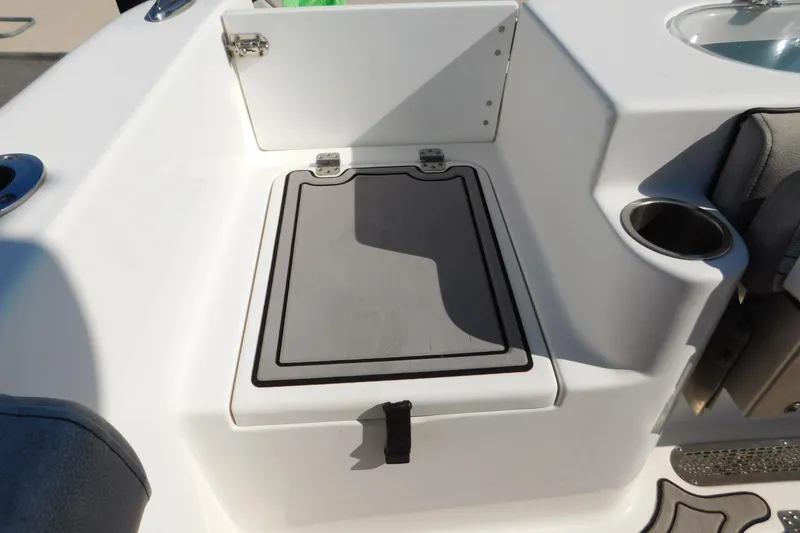 Slide: The Image of 2021 Sea Pro 219 Center Console boat interior with storage compartment and cup holder. - 27