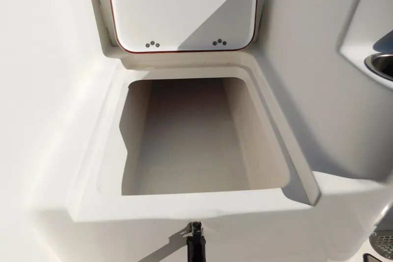 Slide: The Image of 2021 Sea Pro 219 Center Console storage compartment, open and empty. - 28