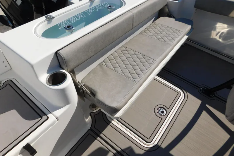 Slide: The Image of 2021 Sea Pro 219 Center Console boat interior with cushioned seating and storage. - 29