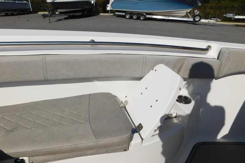 Slide: The Image of 2021 Sea Pro 219 Center Console boat interior with cushioned seating and stainless steel rail. - 36