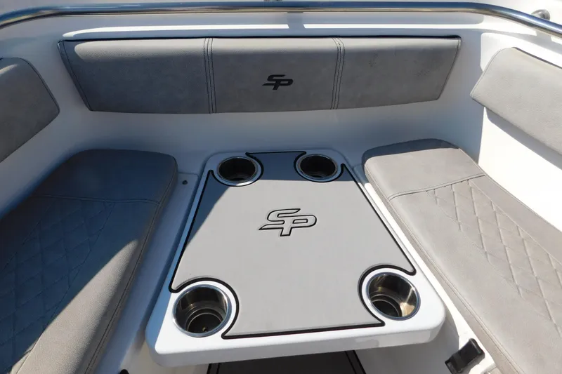 Slide: The Image of 2021 Sea Pro 219 Center Console boat interior with cushioned seating and cup holders. - 37