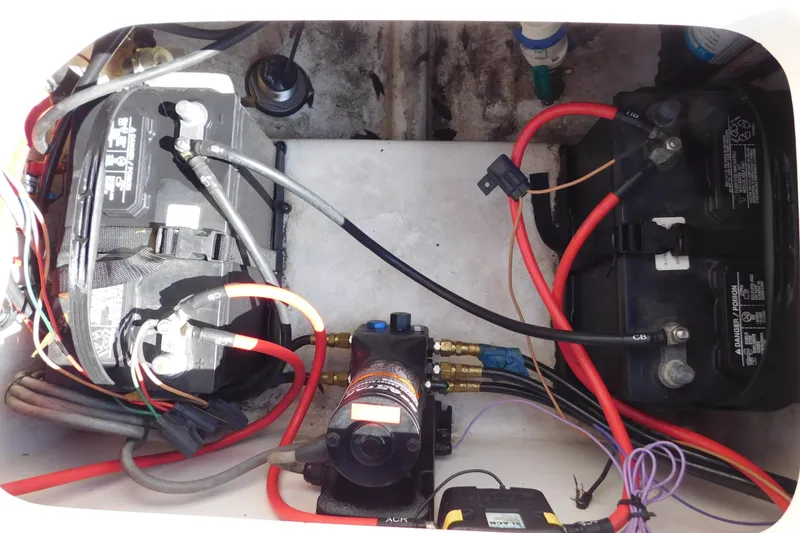 Slide: The Image of 2021 Sea Pro 219 Center Console boat battery compartment with wiring and components. - 43