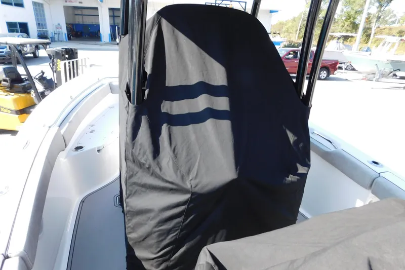 Slide: The Image of 2021 Sea Pro 219 Center Console boat with covered console in a marina setting. - 45