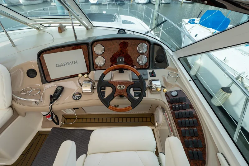 Slide: The Image of Helm of 2005 Sea Ray 500 Sundancer yacht with modern controls and marina view. - 14