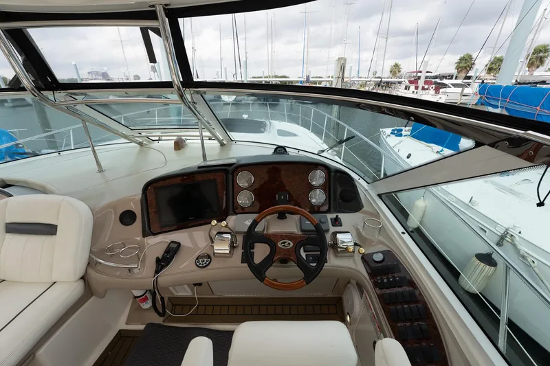 Slide: The Image of Helm of 2005 Sea Ray 500 Sundancer yacht with marina view. - 15