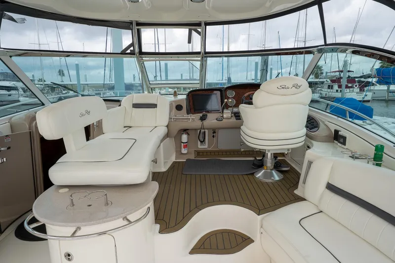 Slide: The Image of 2005 Sea Ray 500 Sundancer yacht docked at marina with sailboats in background. - 21