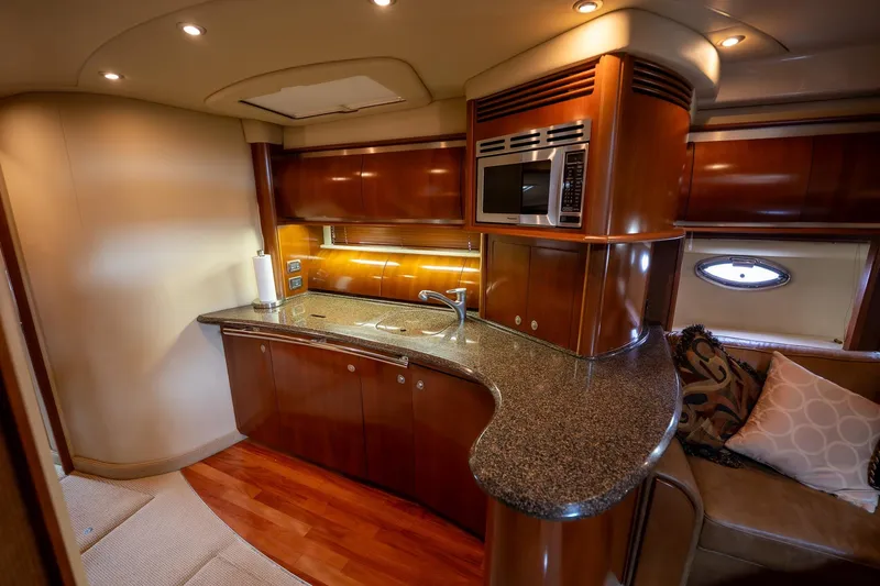 Slide: The Image of Luxurious interior of a 2005 Sea Ray 500 Sundancer yacht with elegant seating and wooden cabinetry. - 27