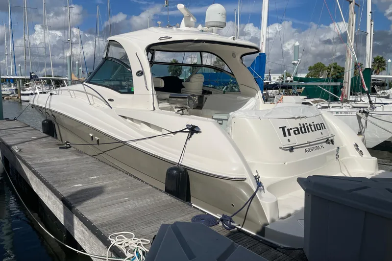 Slide: The Image of 2005 Sea Ray 500 Sundancer yacht docked at marina under cloudy skies. - 3