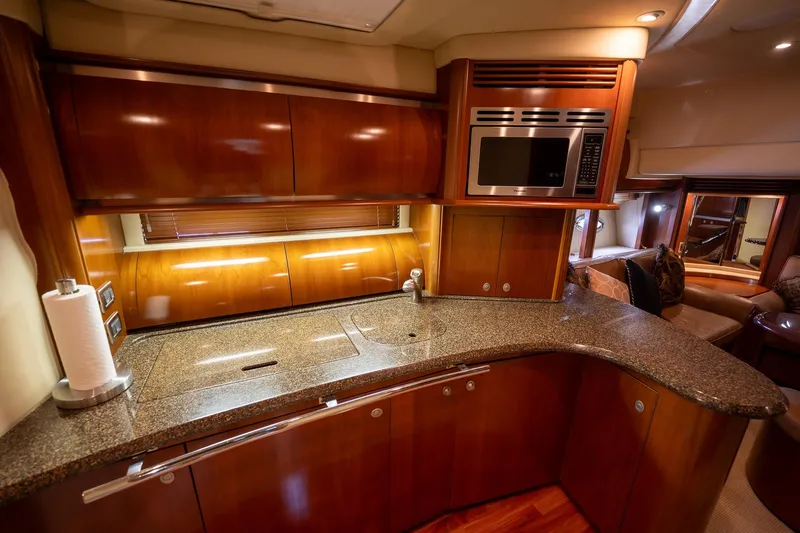 Slide: The Image of Interior of 2005 Sea Ray 500 Sundancer yacht with cozy bunk beds and checkered bedding. - 33