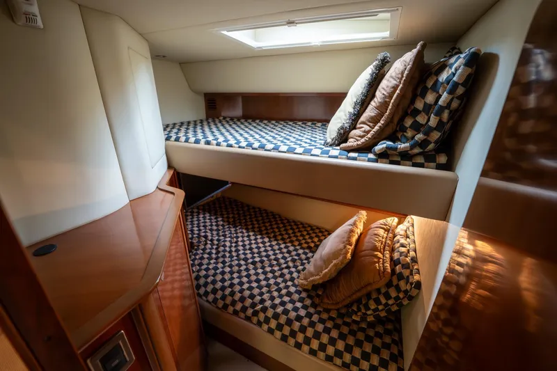 Slide: The Image of Luxurious cabin interior of 2005 Sea Ray 500 Sundancer yacht with TV and checkered bedding. - 35