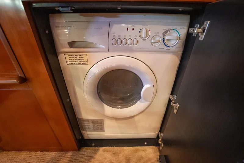 Slide: The Image of Engine compartment of a 2005 Sea Ray 500 Sundancer boat, showcasing detailed machinery. - 45