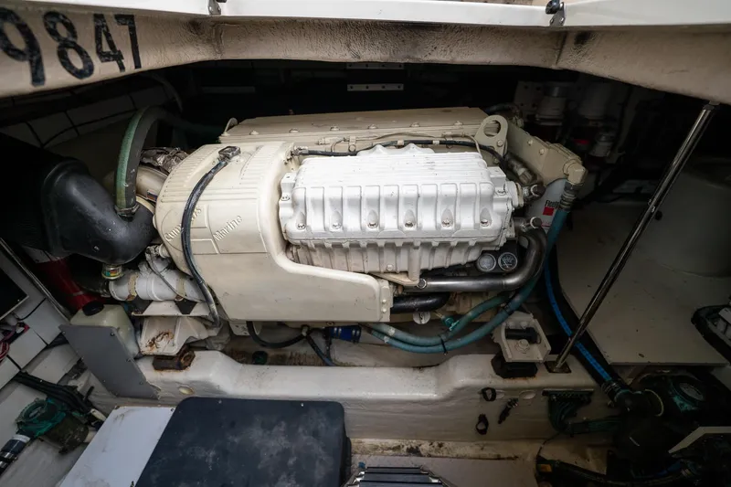Slide: The Image of Engine compartment of a 2005 Sea Ray 500 Sundancer boat, showcasing detailed machinery. - 46
