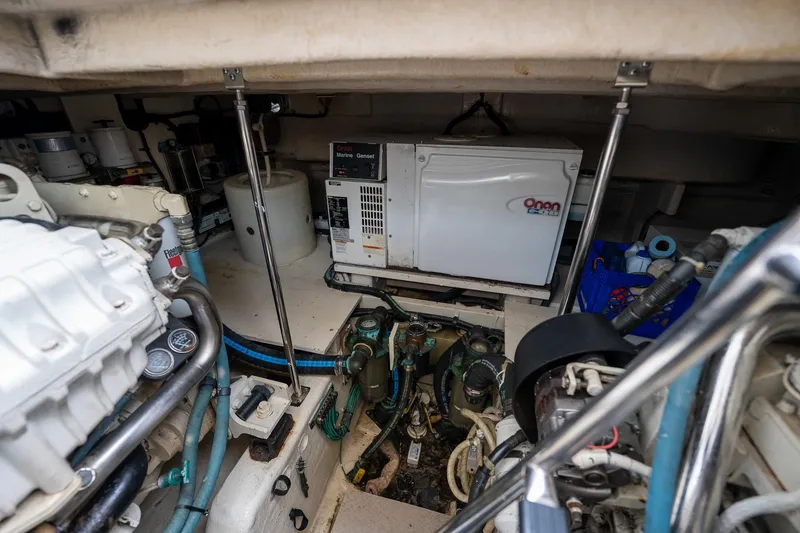 Slide: The Image of Engine room of a 2005 Sea Ray 500 Sundancer with visible machinery and ladder. - 48