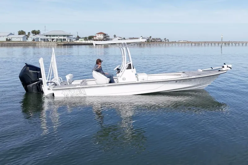 Slide: The Image of 2023 Haynie 25 Magnum boat on calm water, featuring sleek design and powerful engine. - 1
