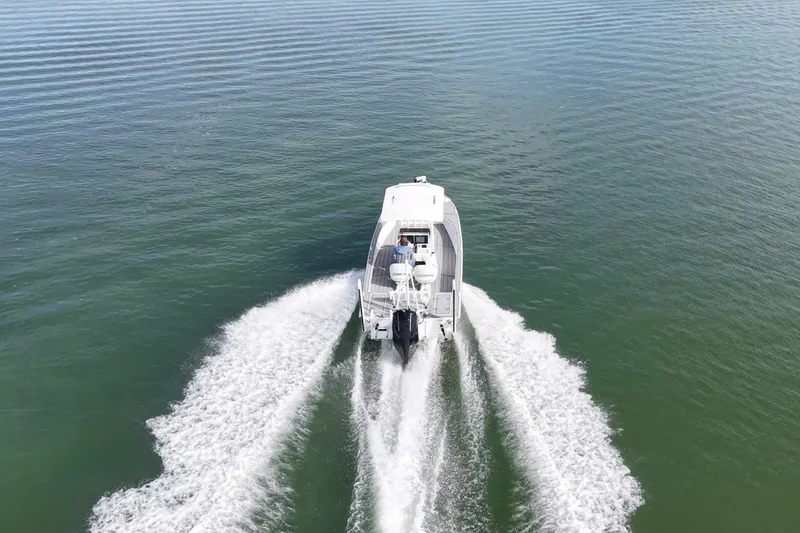 Slide: The Image of Aerial view of 2023 Haynie 25 Magnum boat cruising on open water. - 11