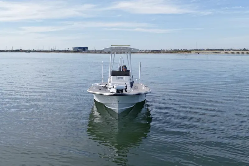Slide: The Image of 2023 Haynie 25 Magnum boat cruising on calm waters under a clear sky. - 3
