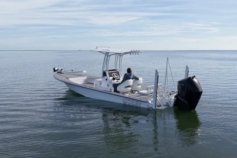 Slide: The Image of 2023 Haynie 25 Magnum boat on calm water, featuring sleek design and modern equipment. - 4