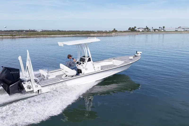 Slide: The Image of 2023 Haynie 25 Magnum boat cruising on calm water, featuring sleek design and powerful engine. - 6