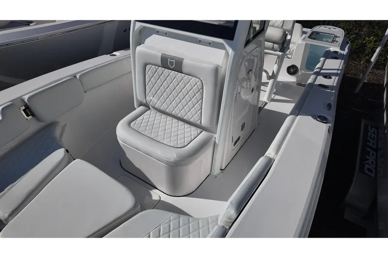Slide: The Image of 2026 Sea Fox 228 Commander boat interior with white cushioned seating and sleek design. - 11