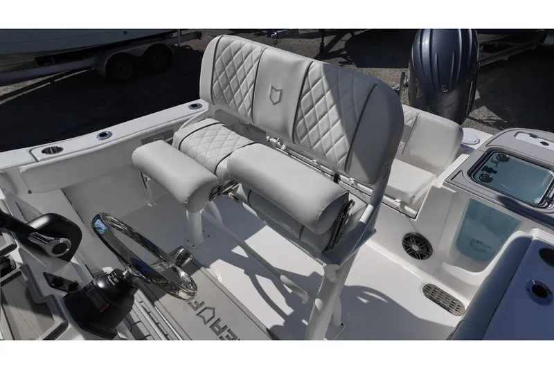 Slide: The Image of 2026 Sea Fox 228 Commander boat interior with steering wheel and cushioned seating. - 15