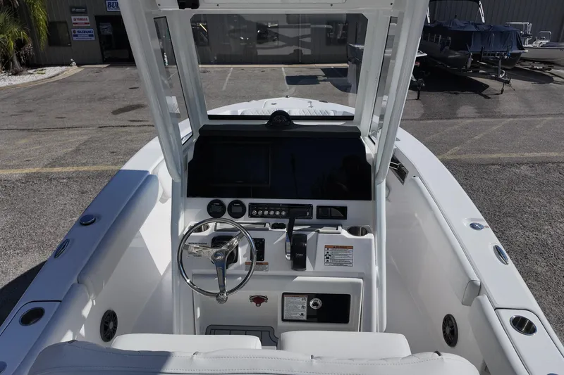 Slide: The Image of 2026 Sea Fox 228 Commander boat cockpit with steering wheel and control panel. - 19