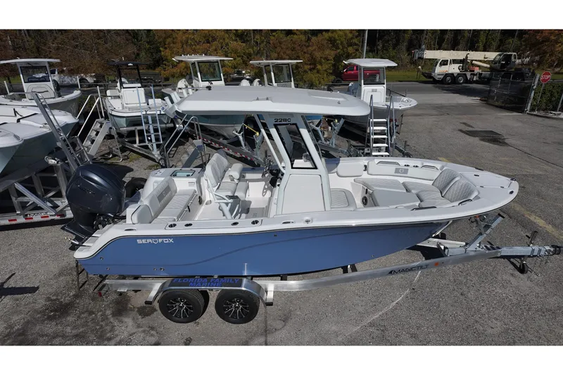 Slide: The Image of 2026 Sea Fox 228 Commander boat on trailer, parked in marina lot. - 2