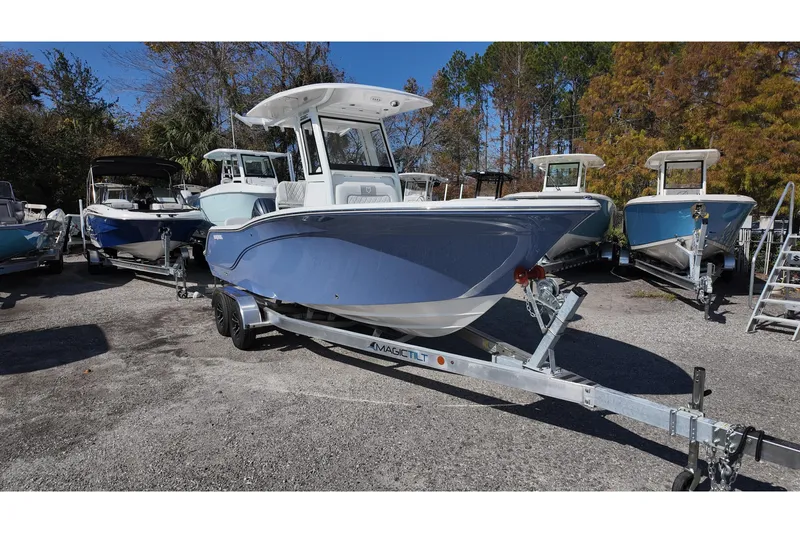 Slide: The Image of 2026 Sea Fox 228 Commander boat on trailer, surrounded by trees and other boats. - 3