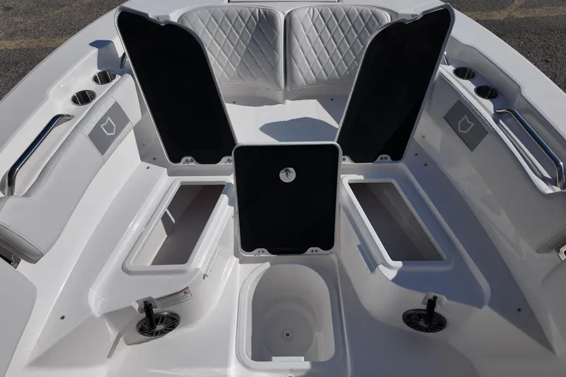 Slide: The Image of 2026 Sea Fox 228 Commander boat interior with open storage compartments and cup holders. - 9