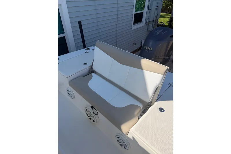Slide: The Image of 2018 Robalo 226 Cayman boat seat with beige and white upholstery, near Yamaha engine. - 11
