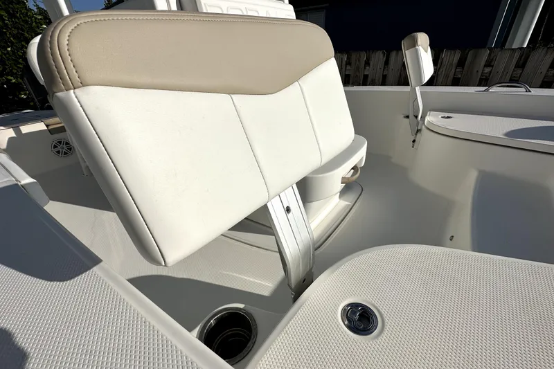 Slide: The Image of 2018 Robalo 226 Cayman boat interior with beige and white seating. - 13
