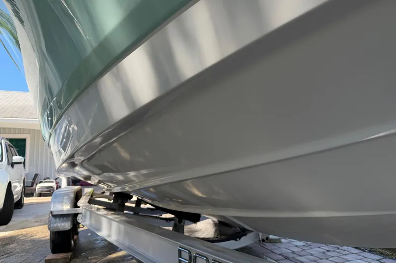 Slide: The Image of 2018 Robalo 226 Cayman boat on trailer, close-up view of hull. - 15