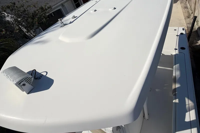 Slide: The Image of 2018 Robalo 226 Cayman boat top view, showcasing sleek white design and equipment. - 17