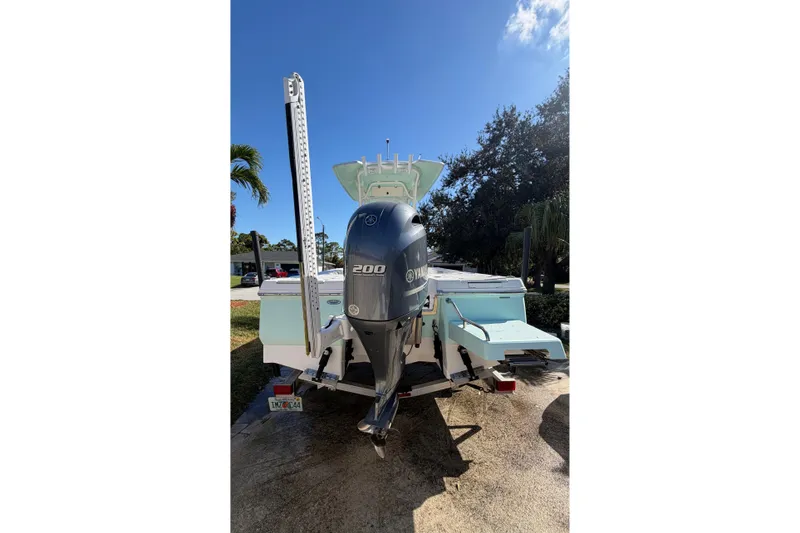 Slide: The Image of 2018 Robalo 226 Cayman boat with Yamaha 200 engine, parked outdoors. - 3