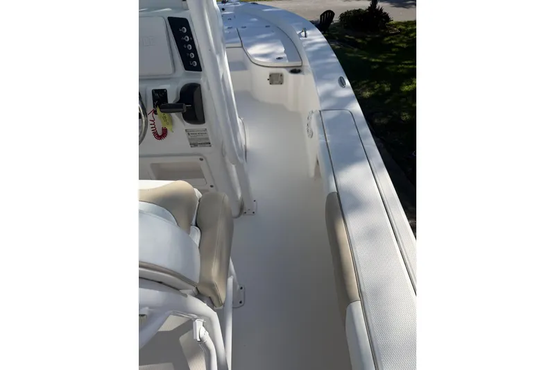 Slide: The Image of 2018 Robalo 226 Cayman boat interior with white seating and control panel. - 9