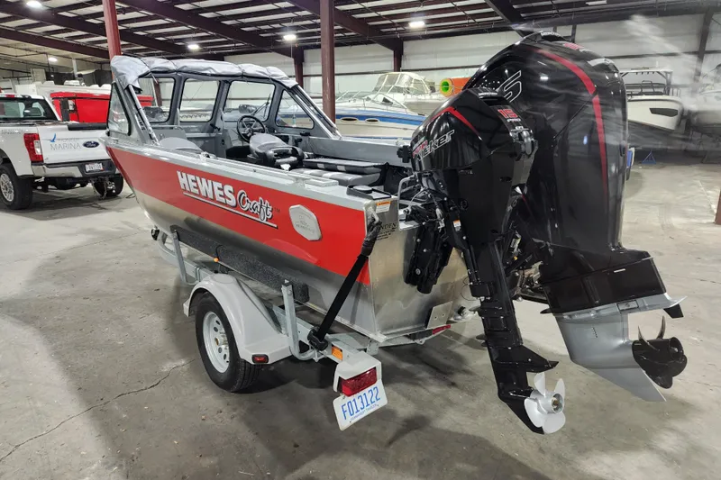 Slide: The Image of 2024 Hewescraft 180 Sportsman boat with outboard motor in a showroom. - 4
