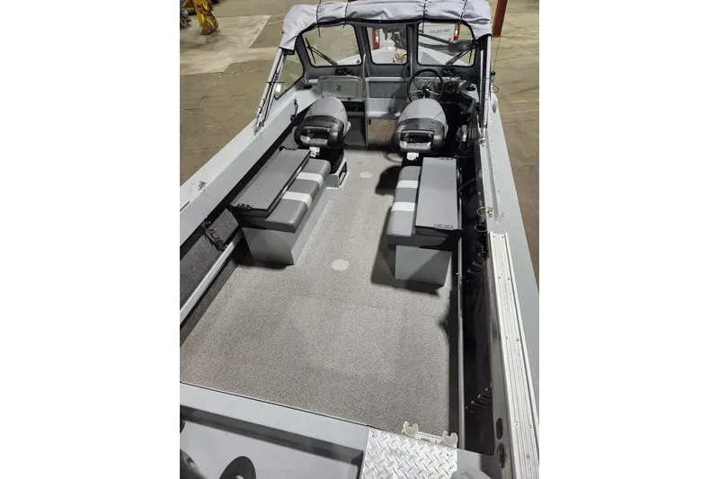 Slide: The Image of 2024 Hewescraft 180 Sportsman boat interior with seating and steering console. - 5
