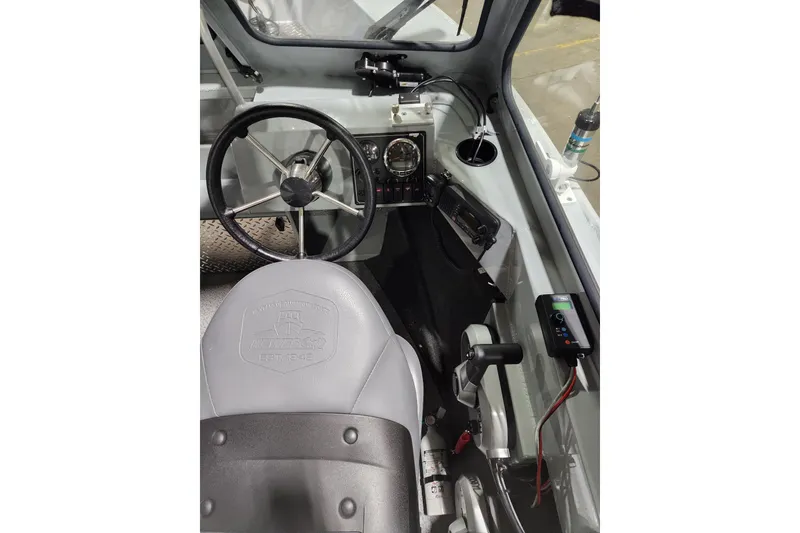 Slide: The Image of 2024 Hewescraft 180 Sportsman boat interior with steering wheel and control panel. - 6